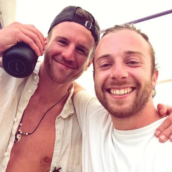Greg and a friend leaning in for a photo together