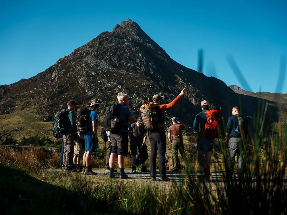 The group walking the approach path toward Tryfan