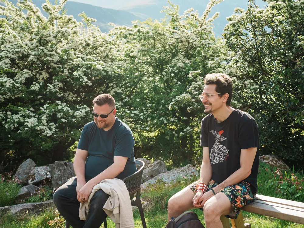 Two men talking by the lake after the swim