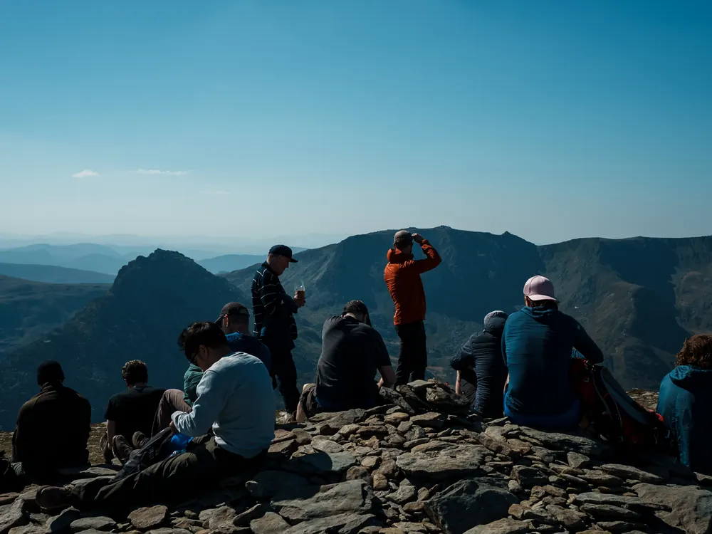 The group resting at a summit, looking out over the range